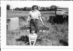 Farm work was shared by the whole family. Herb's wife Mable is shown here in the early 1950s with her niece Judy Potters, bringing in twelve quarts of fresh strawberries from the field.